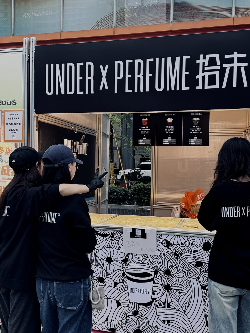 Staff setting up the UNDER x PERFUME booth in Chengdu
